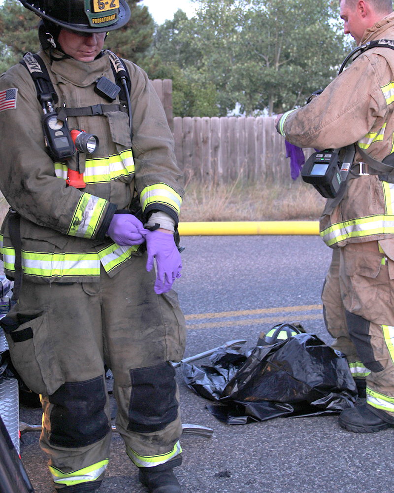 Firefighters removing their gear