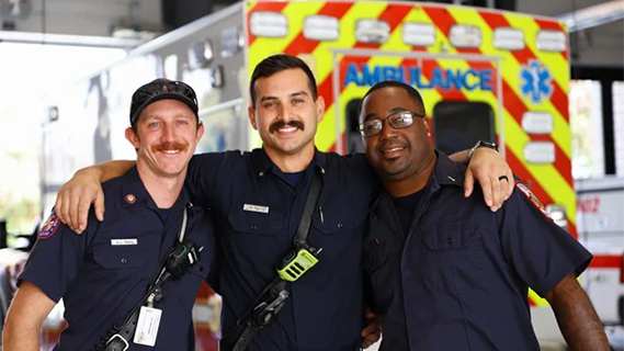 Three EMS personnel with arms joined