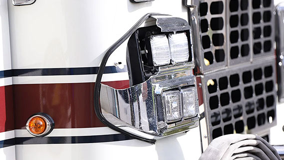 A close-up photo of the headlights on a fire engine